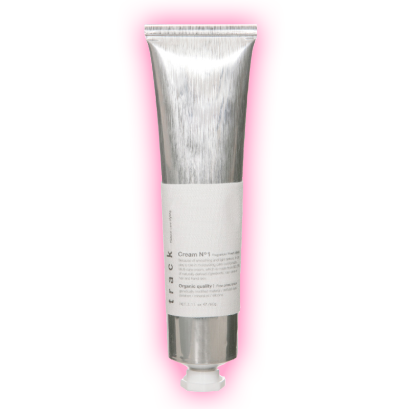 A silver tube of cream with a white label, presented against a pink background.