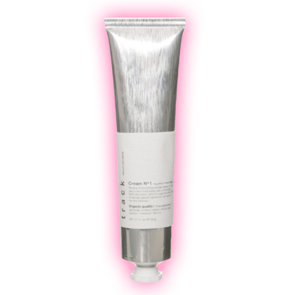 A silver tube of cream with a white label, presented against a pink background.